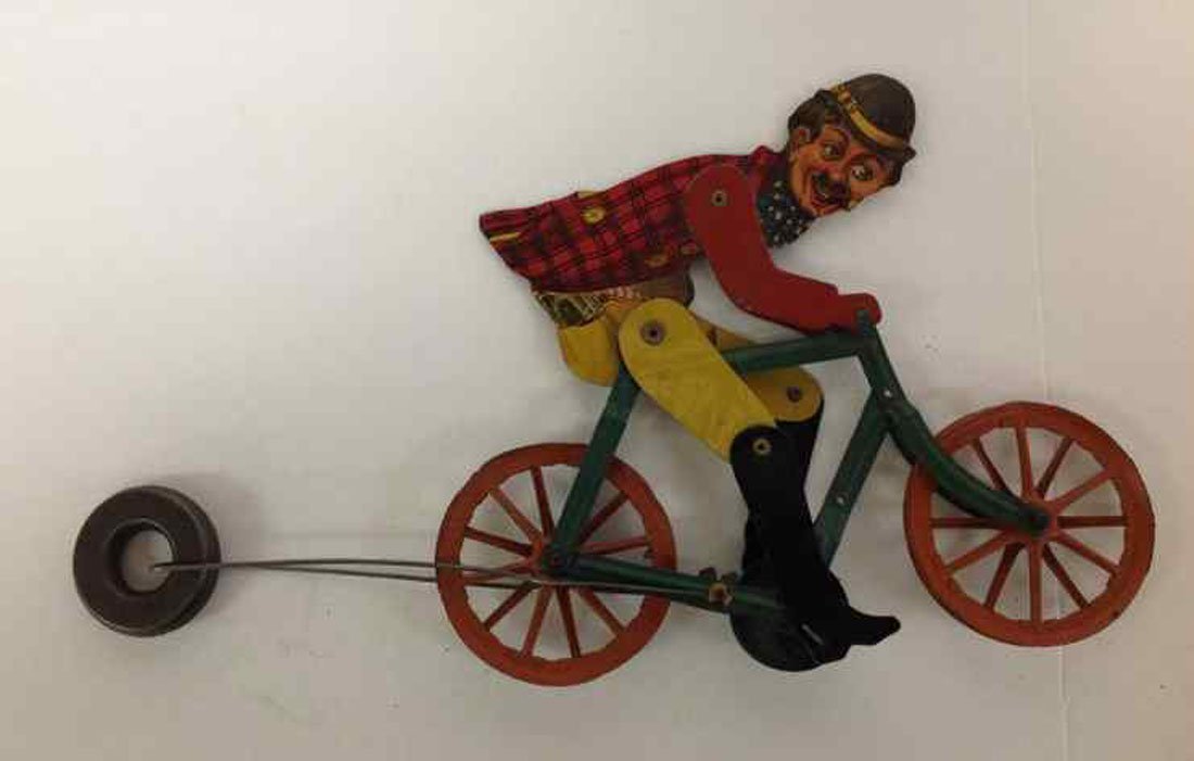 EARLY TIN STRING TOY MAN ON BICYCLE SMOKING CIGAR,: EARLY TIN STRING TOY MAN ON BICYCLE SMOKING CIGAR, WONDERFUL LITHO GRAPHICS. OVERALL REALLY NICE CONDITION, A LITTLE WEAR TO YELLOW PANTS, MEASURES 12" FRONT TO BACK INCLUDING WEIGHT.