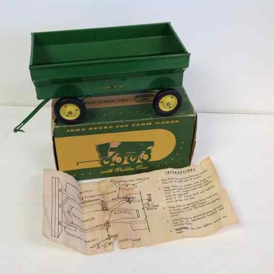 JOHN DEERE EARLY 1950'S TOY FARM WAGON WITH ORIGINAL: JOHN DEERE EARLY 1950'S TOY FARM WAGON WITH ORIGINAL BOX(TAPED), MEASURES 11" FRONT TO BACK, HAS SOME PAINT WEAR, FROM OLD FAMILY ESTATE IN COLORADO, AS PICTURED