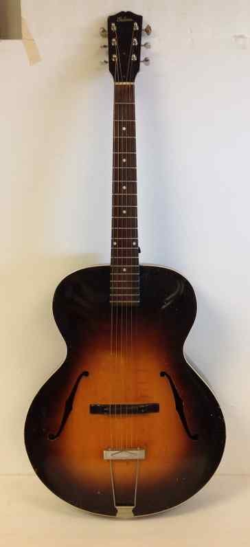 GIBSON 1936 ARCH TOP DOUBLE F HOLE GUITAR, ORIGINAL: GIBSON 1936 ARCH TOP DOUBLE F HOLE GUITAR, ORIGINAL CONDITION, HAS SOME SPLITS ON BACK AS PICTURED. SHOT THE CONDITION FROM ALL OVER FOR YOU TO SEE. PLEASE EMAIL ANY QUESTIONS AND WE WILL ANSWER BEST