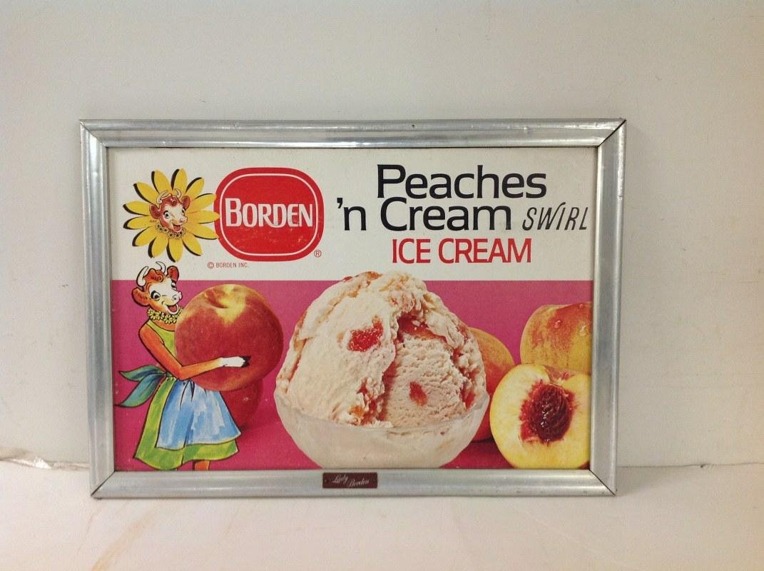 EARLY BORDEN PEACHES 'N CREAM SWIRL ICE CREAM SIGN,: EARLY BORDEN PEACHES 'N CREAM SWIRL ICE CREAM SIGN, CARDBOARD SIGN IN ALUMINUM FRAME, FRAME MEASURES 15" X 21 1/2', HAS LADY BORDEN ON SIGN, AS PICTURED