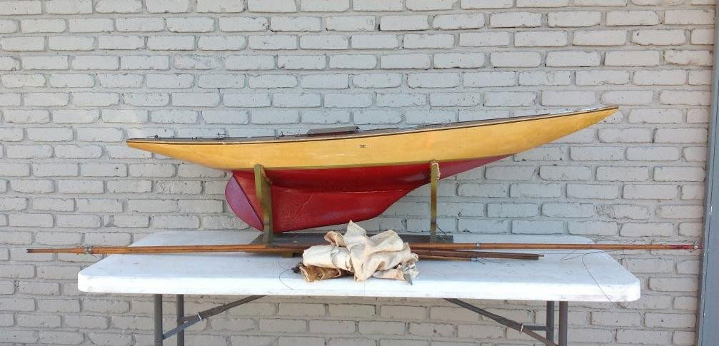 EARLY 71" POND BOAT WITH MASTS AS PICTURED, OLD YELLOW: EARLY 71" POND BOAT WITH MASTS AS PICTURED, OLD YELLOW RED PAINT, ON STAND, SAILS WERE INSIDE, FROM OLD BROOKLYN NEW YORK ESTATE, AS FOUND CONDITION WITH MANY YEARS OF DUST, AS PICTURED