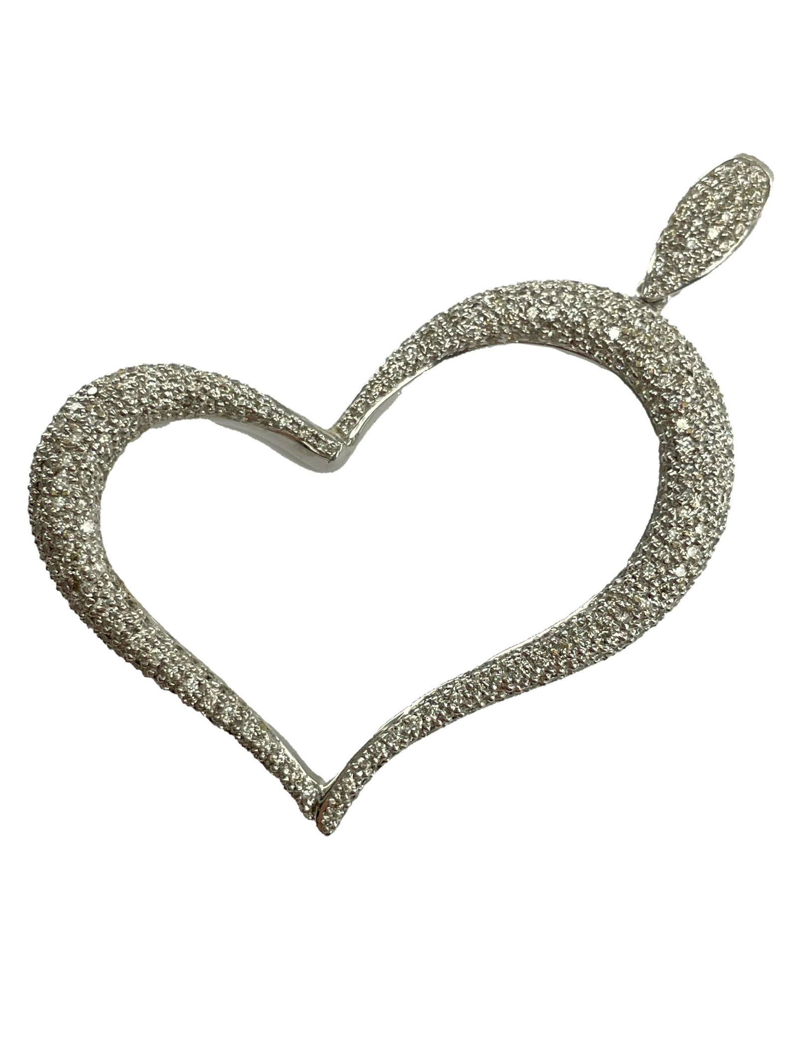 An 18K White Gold Pave Diamond Heart Pendant: An 18kt white gold heart pendant with pavÃ© set diamonds. Bail marked 18k 750. Heart 2” diagonal from top of bail to opposite side. 1 3/8” long. 7.9 dwt.