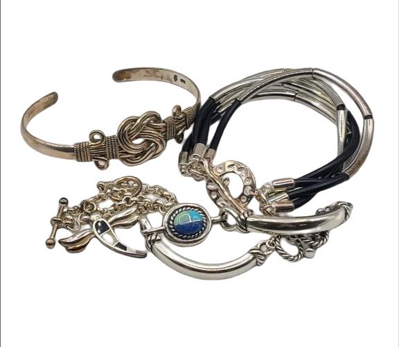 Lot of 4 Silver Bracelets: These are all marked 925 or sterling silver. See photos for weight and details. One has leather interior straps. Our Shipper processes shipments via Shipping Saint. They charge a $6 per lot flat handl