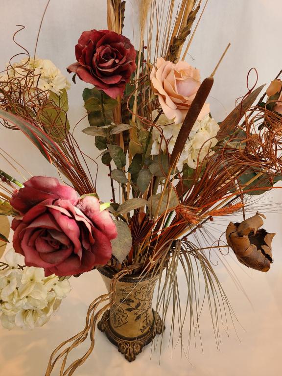 Floral Arrangement in a Nice Pottery Vase: This is a huge arrangement. The vase is around 13.5" tall by 8" wide. We believe the vase is clay or terracotta. The total height and width of this arrangement is around 48". We couldn't even show the