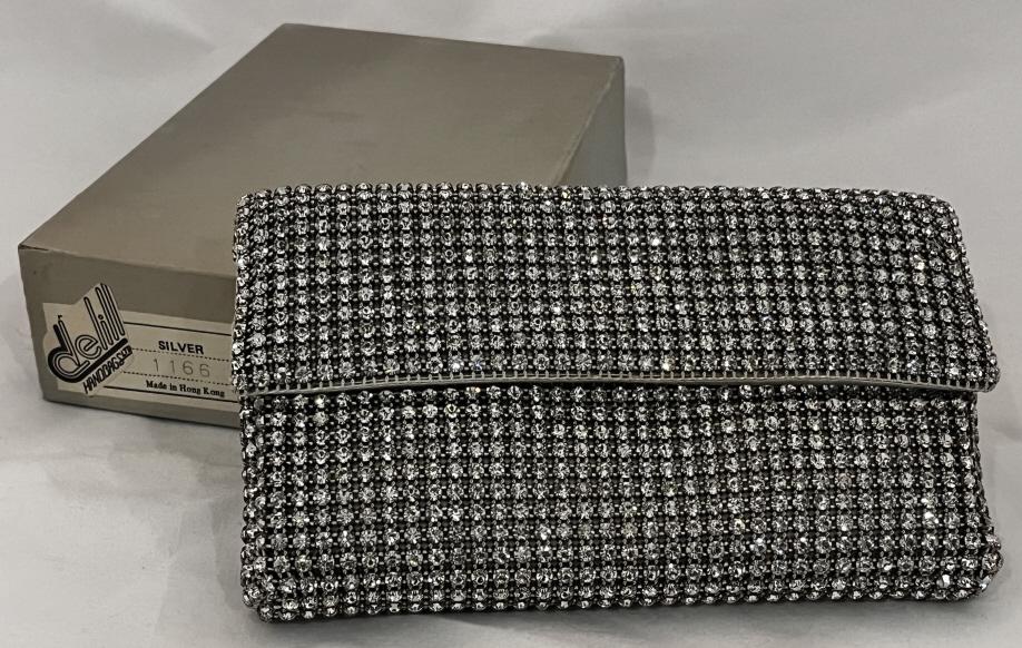 Vintage Delill Rhinestone Handbag: Delill Handbag, rhinestone embroidered. Made in Hong Kong and includes the original packaging. Measures approximately 7.5" by 4.5" and has some depth and some weight. We don't see any rhinestones miss