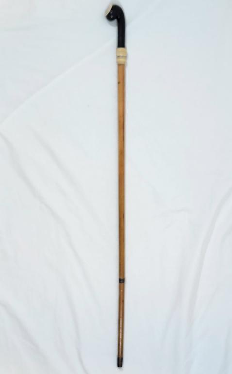 Antique Bone Handle Sword Cane: Polished wood cand with bone wrap and bone pendant on the handle, the handle features an image of a rooster on a fence. This cane can actually be unsheathed into a sword as shown. Please note that it 