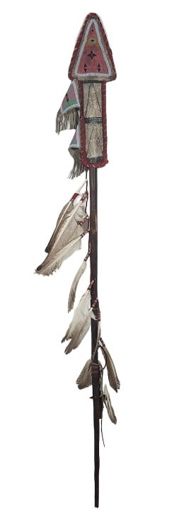 Native American Hunting Warrior Spear: Hand carved spear believed to be Native American in origin, features a carved bone tip and sleeve with patterned beadwork and feathers adorned in a tail like fashion along the bottom. Measures 63" lon