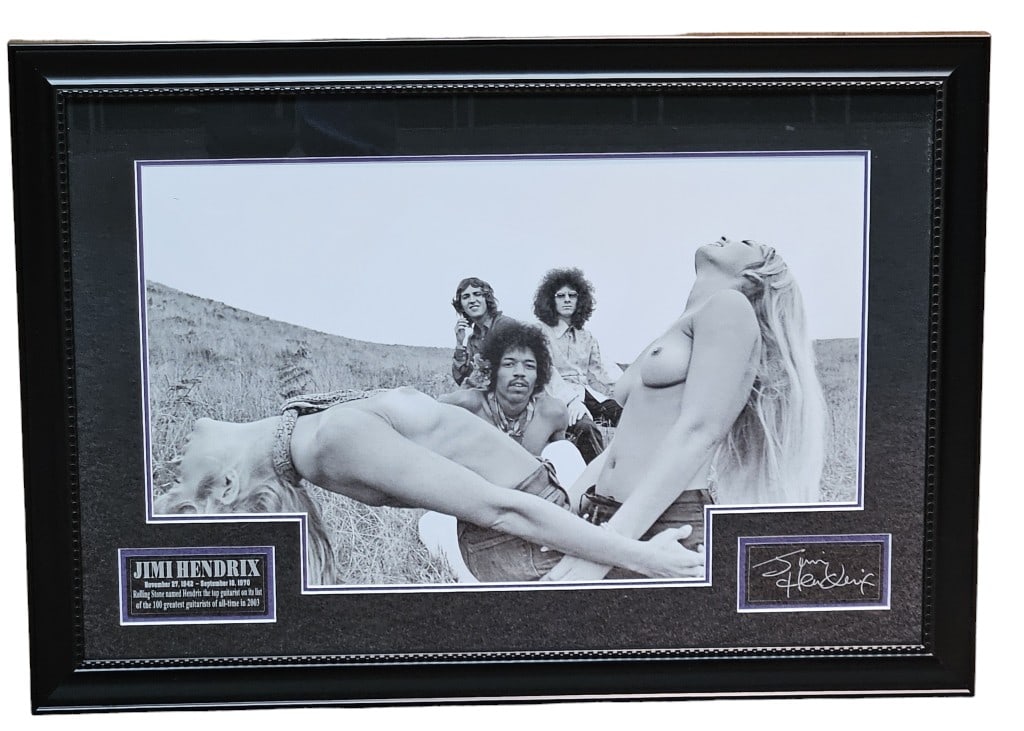 Jimi Hendrix Band Erotic Photo Shoot Display: 31" by 22" framed out display includes black and white photo print of Jimi Hendrix and band in erotic photo shoot. Bottom right signature is printed or autopen, not hand signed.