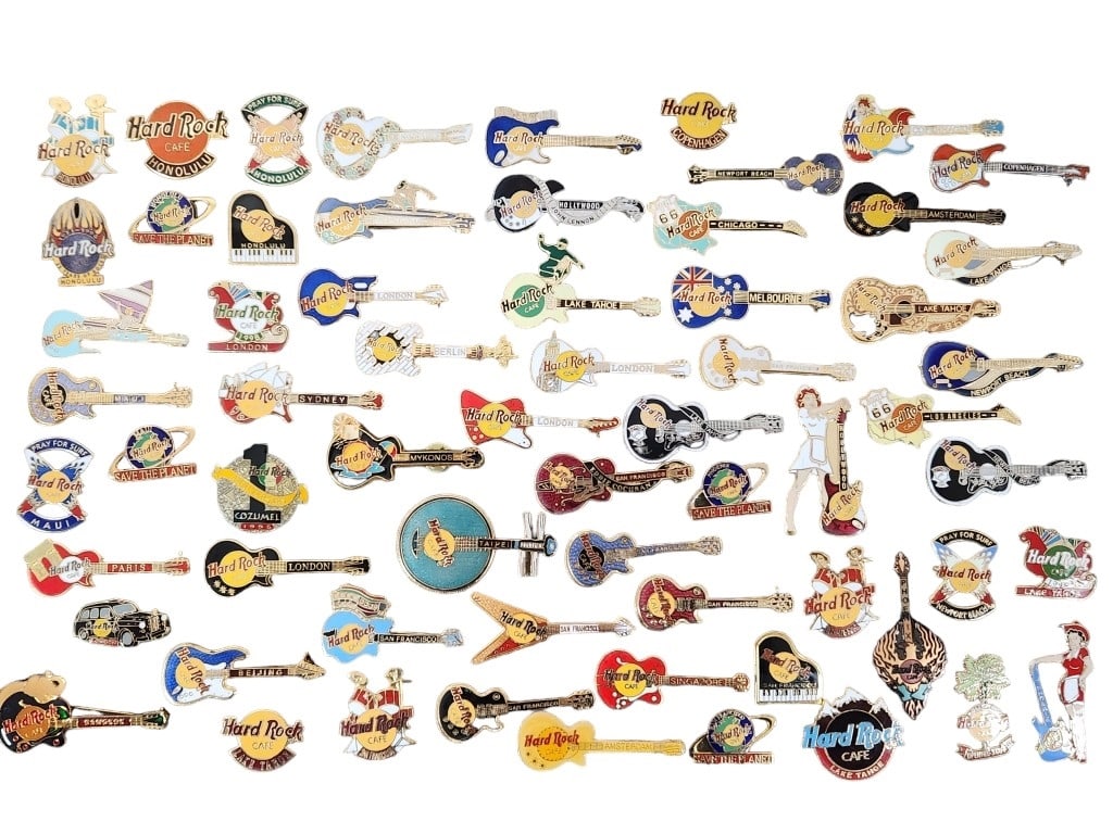 Hard Rock Cafe Casino Guitar Trading Pins: 63 enamel trading pins from the Hard Rock family of Casinos, Hotels, and Cafes. The pins are housed in a shadowbox case measuring 18" x 12" x 1 3/4". Some pins may have foam stuck to the back due to t