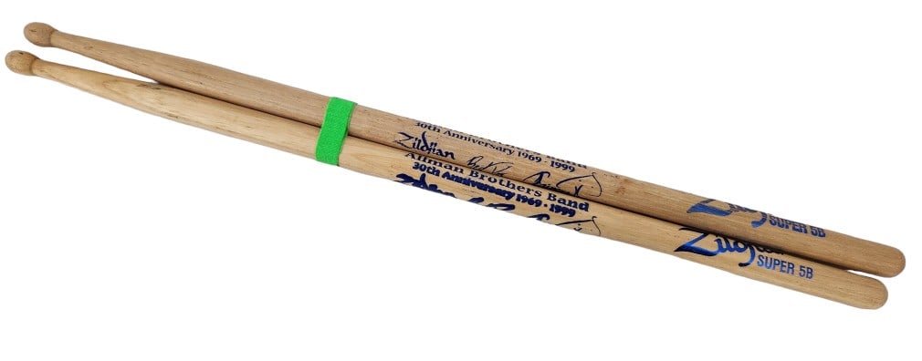 Allman Brothers Band 30th Drum Sticks 16 3/8": Pair of concert used 1999 Allman Brothers Band 30th Anniversary Zildjian drum sticks, each features the dates "1969-1999" and printed signatures of members from the band. This lot will come with a Leg