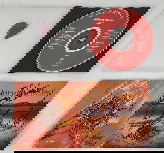 Alice in Chains Signed CD & Inez Lollapalooza Pick: Alice in Chains "Dirt" CD with insert signed by Jerry Cantrell, Layne Staley, Mike Inez, and Sean Kinney. Also includes a 1993 Lollapalooza Mike Inez signature guitar pick. This lot will come with a L