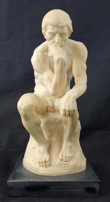 The Thinker A. Santini Sculpture: "The Thinker" A. Santini sculpture made from alabaster or resin on a marble base. Original Santini label on the bottom of the base. Measures 5 1/4" x 10 1/2" x 5" D. 5.25 lbs.