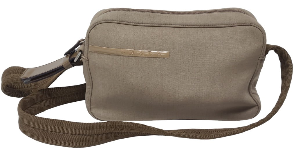 Prada Tan Sport Canvas Crossbody Bag: This piece has the correct markings as similar examples and has 2 'control' tags on the inside of zippered pocket on the inside of the purse. In used but very good condition. See photos for size. *We