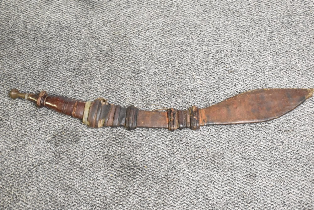 A Nigerian Takouba type Sword.leather grip with brass pommel, leather scabbard with leaf shaped (1 of 3)