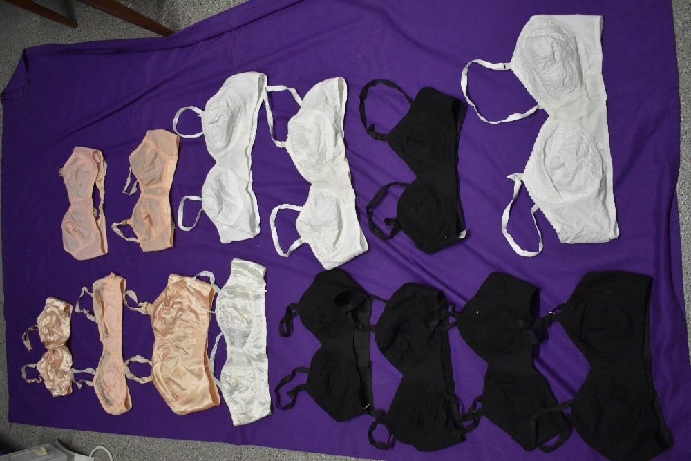 Fourteen vintage 1940s and 50s bras, some multiples of the same style in black and white, others: Fourteen vintage 1940s and 50s bras, some multiples of the same style in black and white, others in pink and white satin finish and nylon.