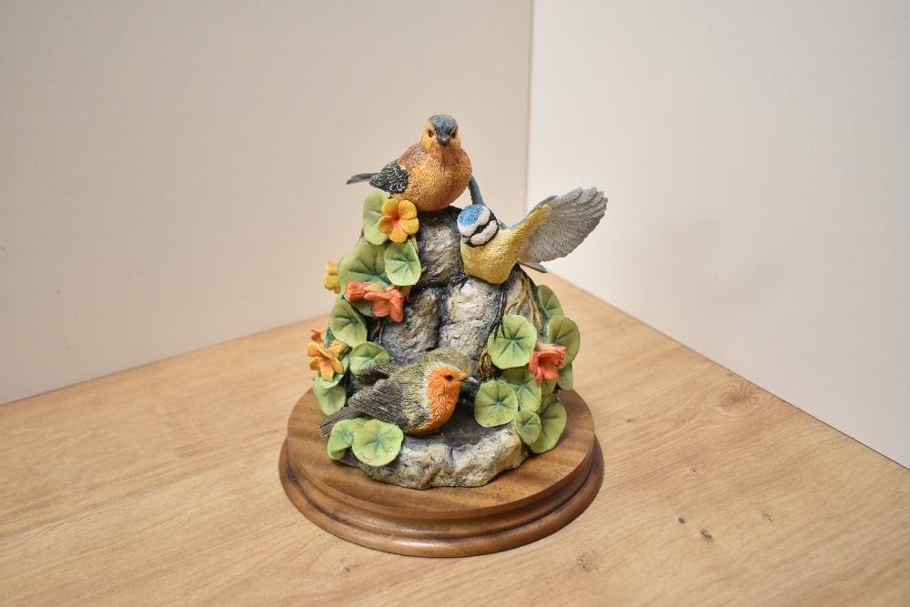 A Border Fine Arts bird group 'After The Rain' SOC5 with moulded circular mahogany plinth, label: A Border Fine Arts bird group 'After The Rain' SOC5 with moulded circular mahogany plinth, label to base 18cm