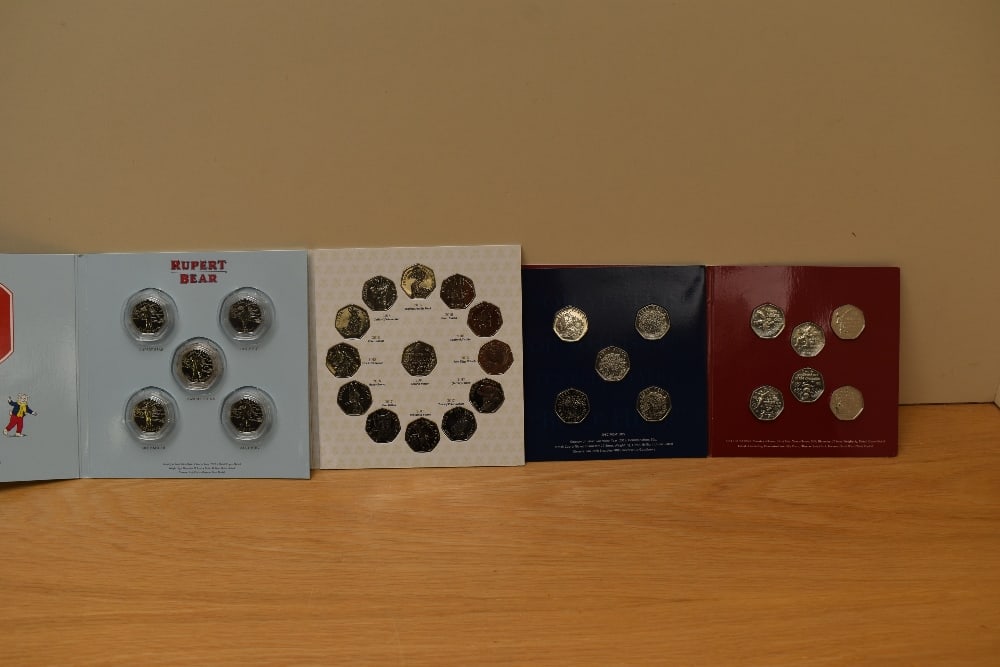 Four Coin Sets, The World of Beatrix Potter UK 50p Coin Album containing 13 coins 2016-2018, 2019: Four Coin Sets, The World of Beatrix Potter UK 50p Coin Album containing 13 coins 2016-2018, 2019 Peter Pan IOM 50p Coin Collection containing 6 coins, Westminster Mint Pantomime Guernsey 50p Coin Col