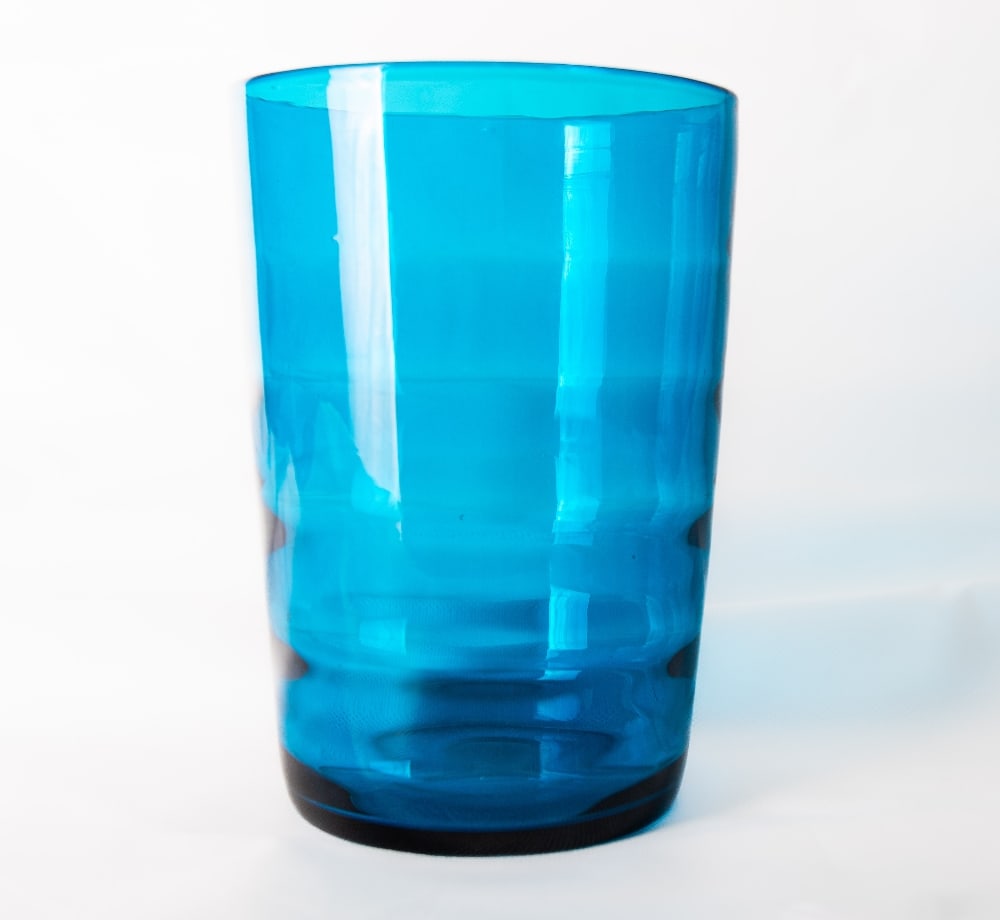 A Whitefriars glass blue internally ribbed optic tumbler vase, of cylindrical form, designed by (1 of 2)