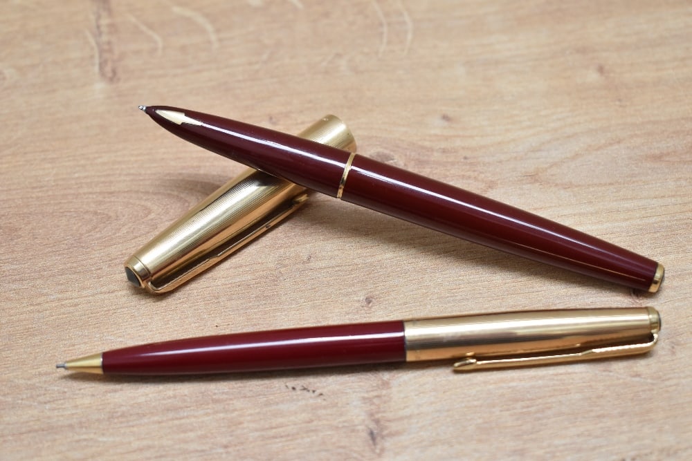 A Parker 61 Custom capillary fill fountain pen, and propelling pencil set in burgundy with rolled (1 of 3)