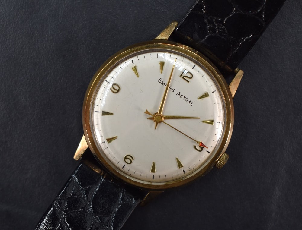 A gent's 9ct gold Smiths Astral manual wrist watch having Arabic quarter numerals and baton dial: A gent's 9ct gold Smiths Astral manual wrist watch having Arabic quarter numerals and baton dial with red pointer sweeping seconds hand on silvered face in gold case having British Railways presentati