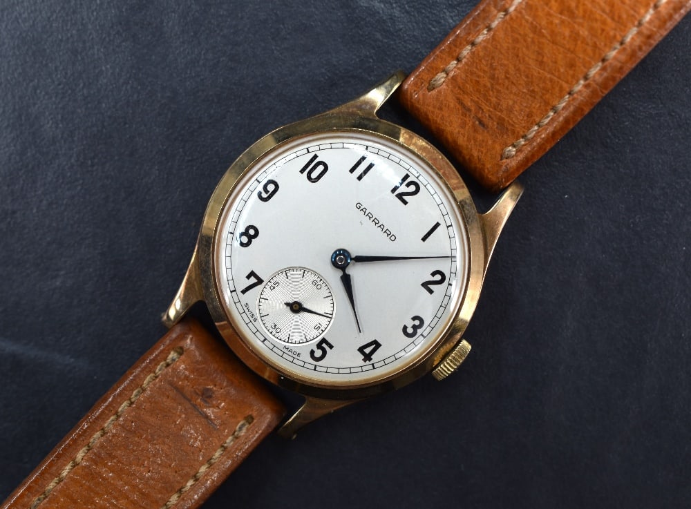 A gent's vintage 9ct gold manual wrist watch by Garrard having Arabic Numeral dial with subsidiary (1 of 5)