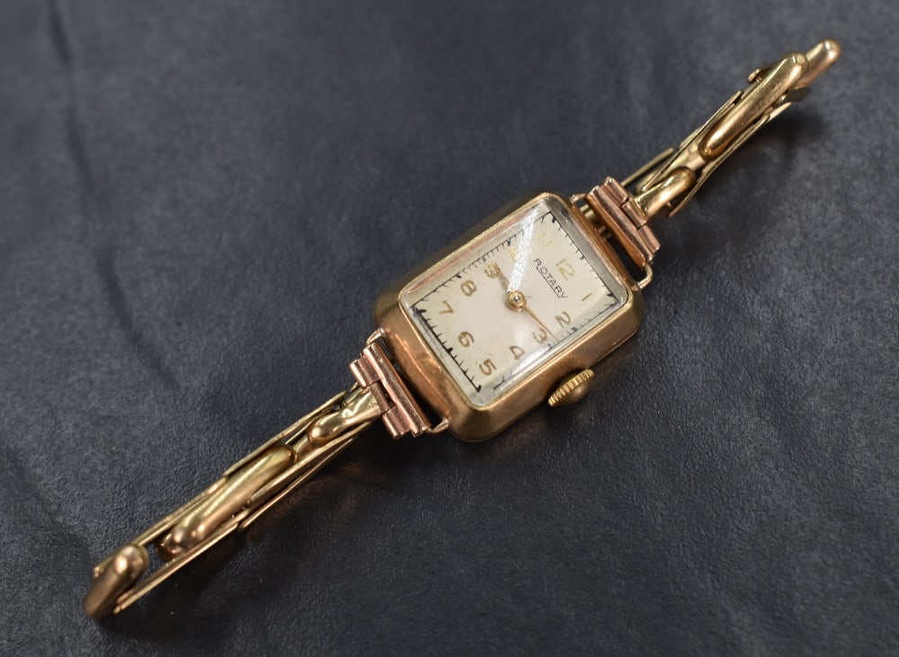 A 9ct gold Rotary wristwatch, the rectangular white dial having Arabic numerals, on a 9ct gold (1 of 5)