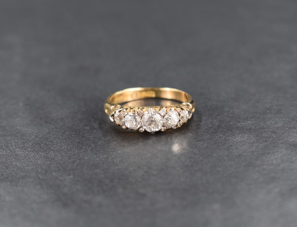 A Victorian 5 stone graduated diamond ring having five old cut diamonds with eight diamond chip (1 of 3)