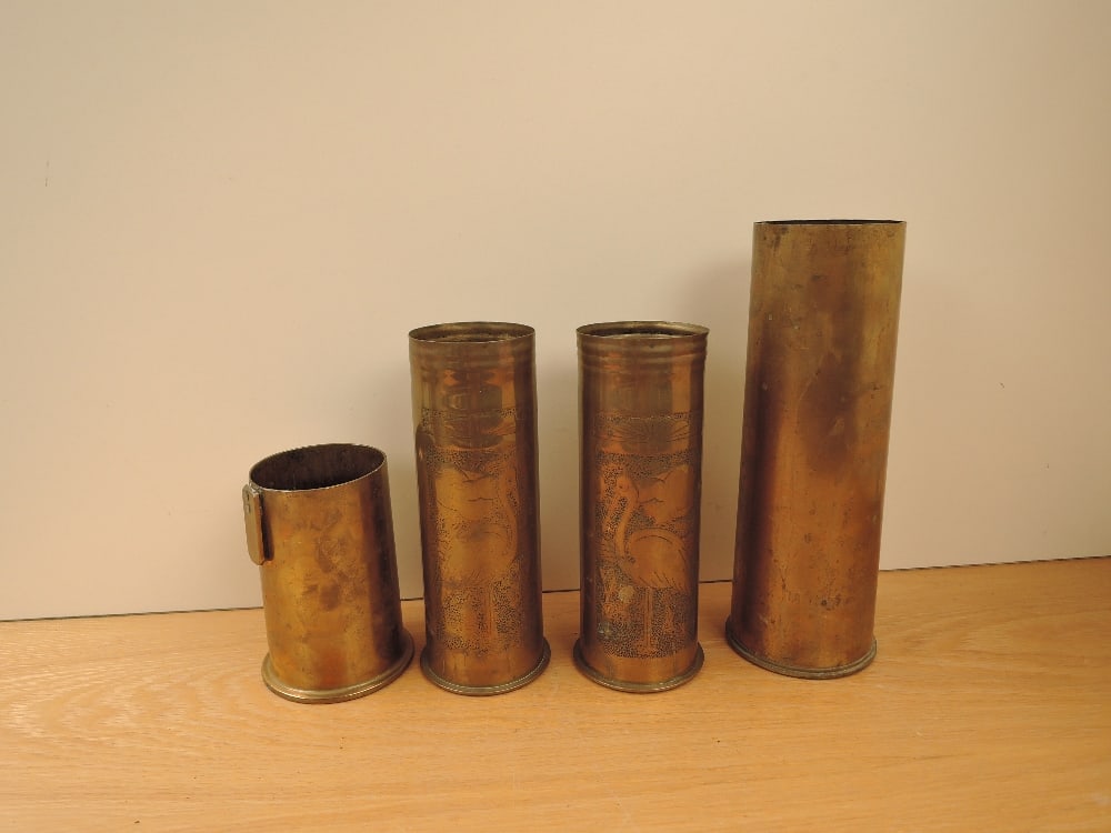 A pair of Trench Art Brass Shells dated 1915 & 1917 decorated with Cranes or Flamingo's height: A pair of Trench Art Brass Shells dated 1915 & 1917 decorated with Cranes or Flamingo's height 23cm along with to plain Shells height 15cm dated 1918 and height 29cm dated 1938 25 pounder