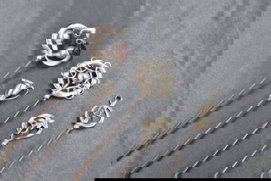A group of five Charles Horner silver hat pins of various design, sold along with the base of a