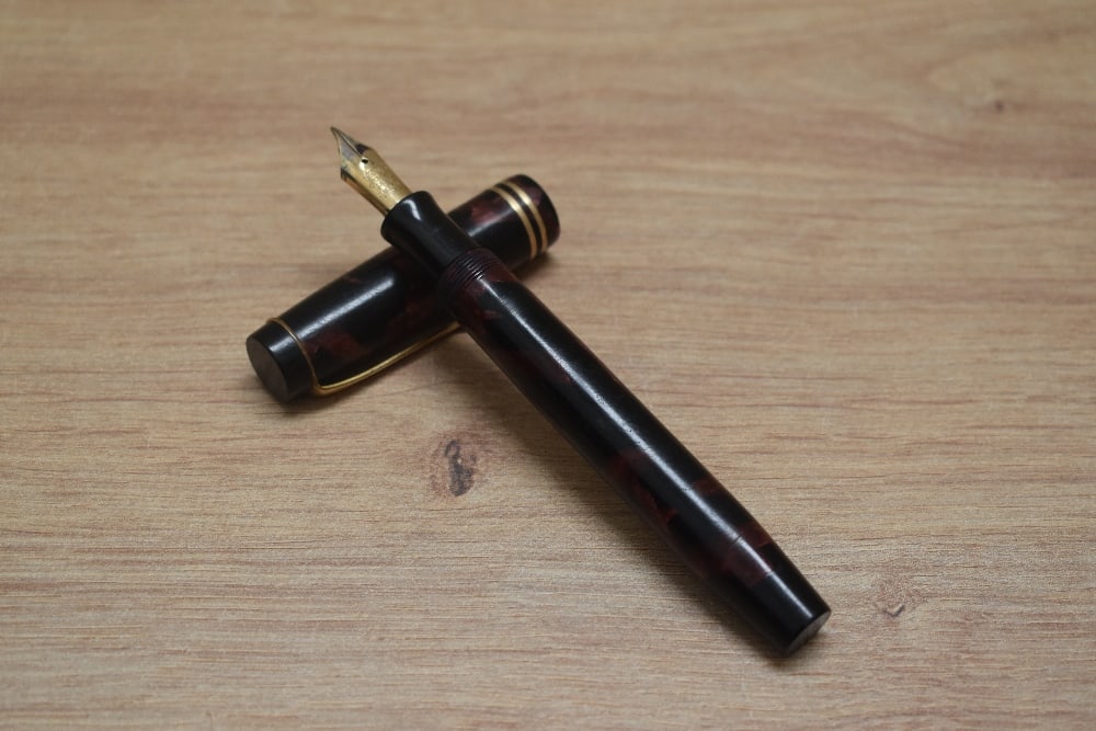 A Parker Duofold Senior Streamlined button fill fountain pen in rose and black with two cap bands (1 of 3)