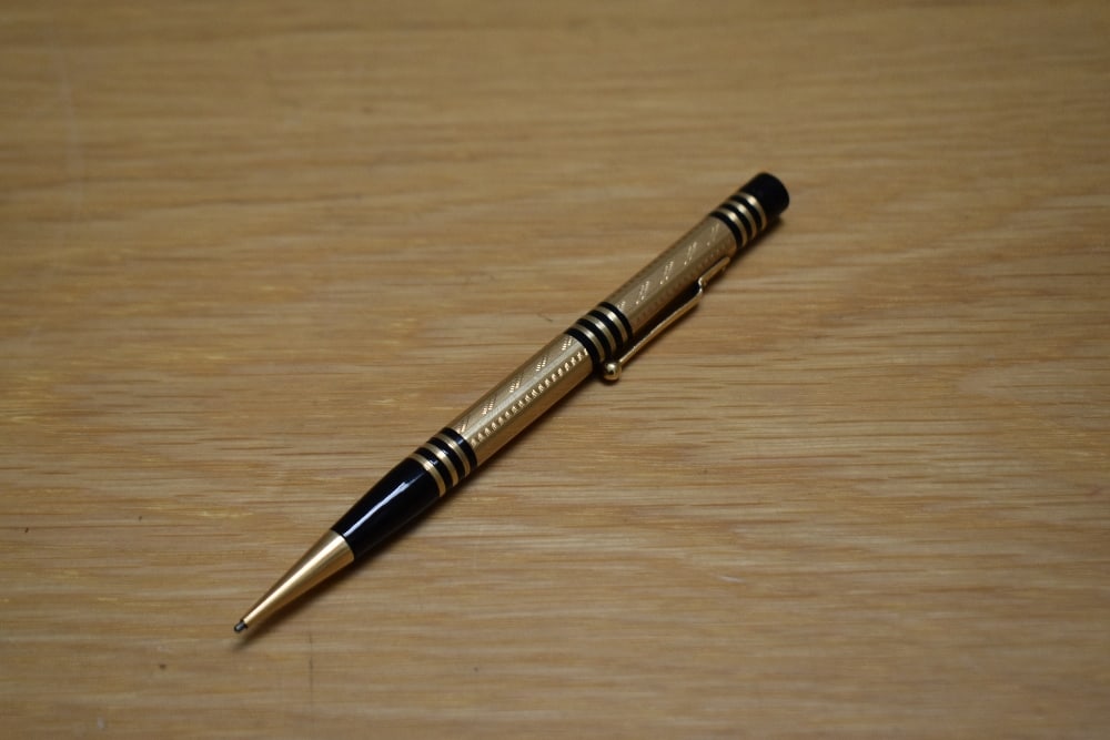 A Mabie Todd & Co Fyne Poynt propelling pencil set in black with gold overlay and several decorative (1 of 1)