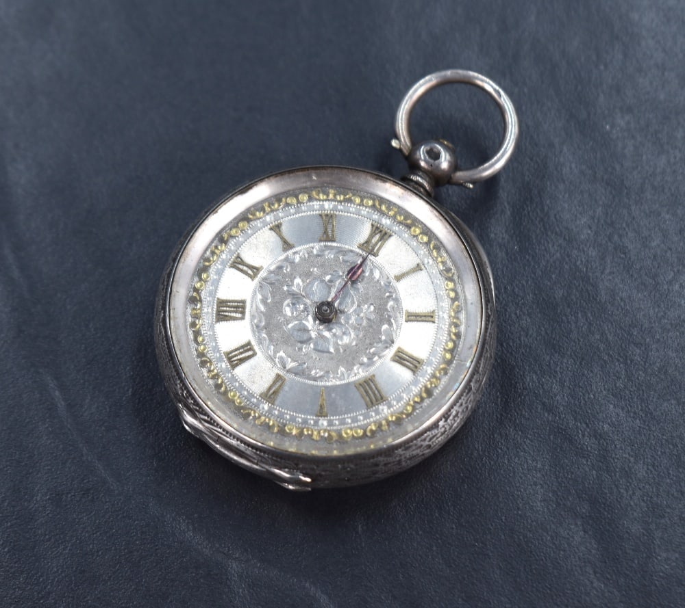 A small silver open face key wound pocket watch, the silver and gold tone dial with Roman (1 of 4)