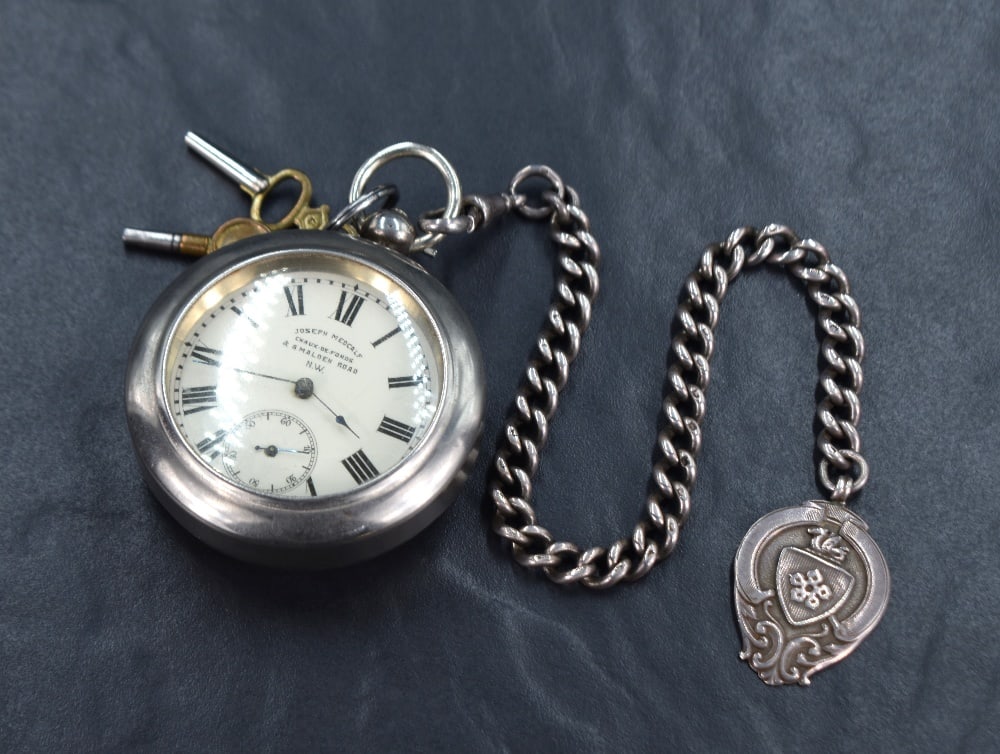 A French silver key wound pocket watch having Roman numeral dial with subsidiary secionds on a white (1 of 4)
