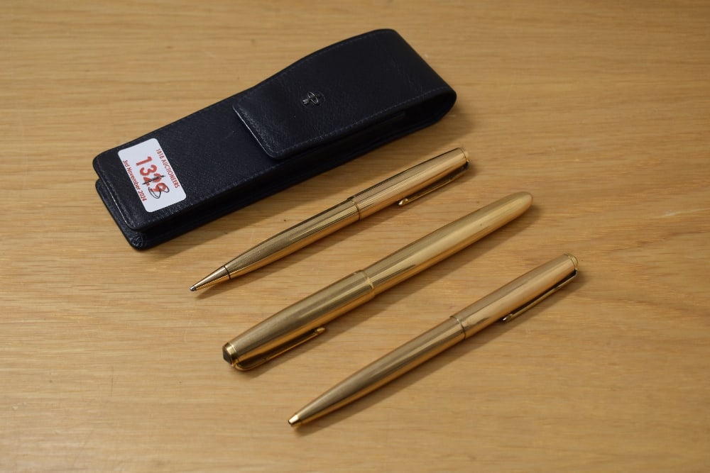 A Parker 51 consort aeromatic fill fountain pen, ballpoint pen, and propelling pencil in rolled (1 of 2)