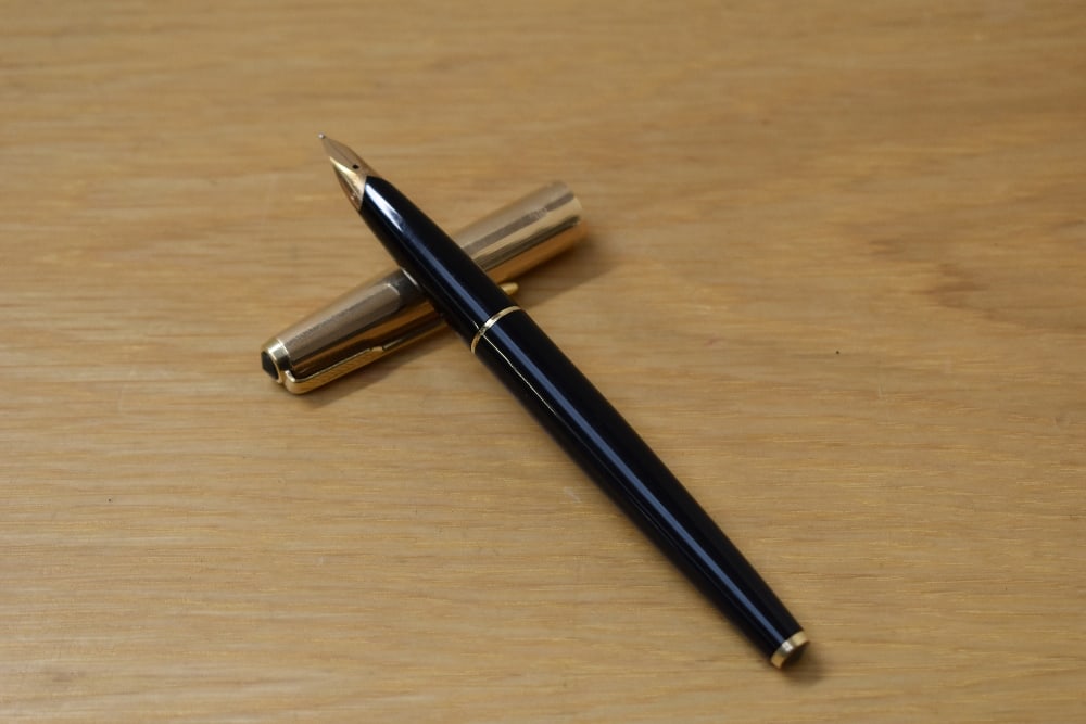A Parker 65 Custom aerometric fill fountain pen in black with rolled gold cap having Parker 14k (1 of 3)