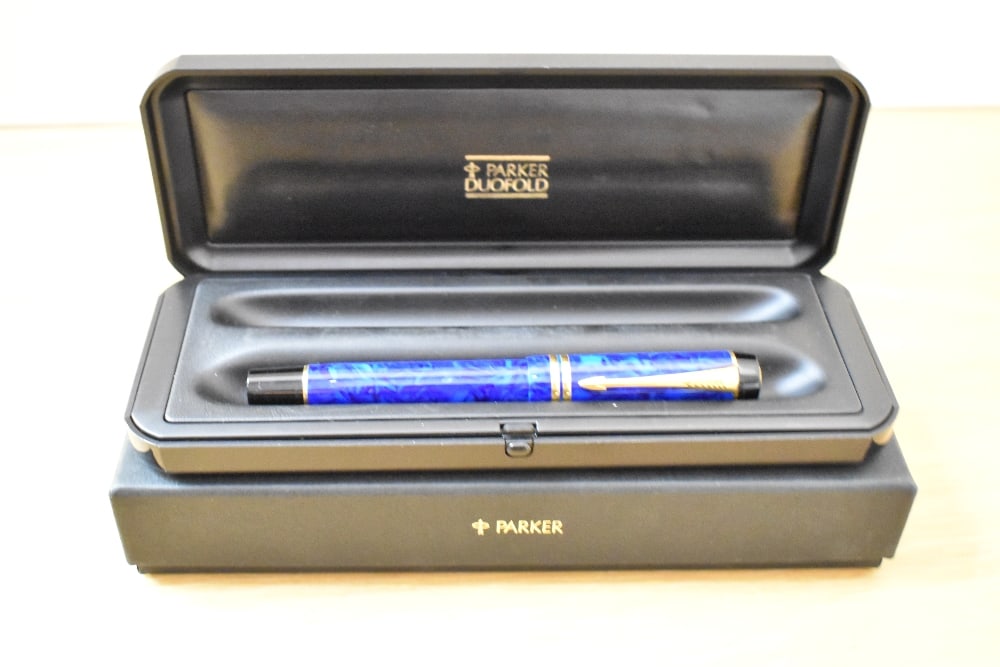 A boxed Parker Centenial MKII converter/Cartridge fill fountain pen in Lapis Lazulii with two cap: A boxed Parker Centenial MKII converter/Cartridge fill fountain pen in Lapis Lazulii with two cap bands having a Parker 18K 750 nib