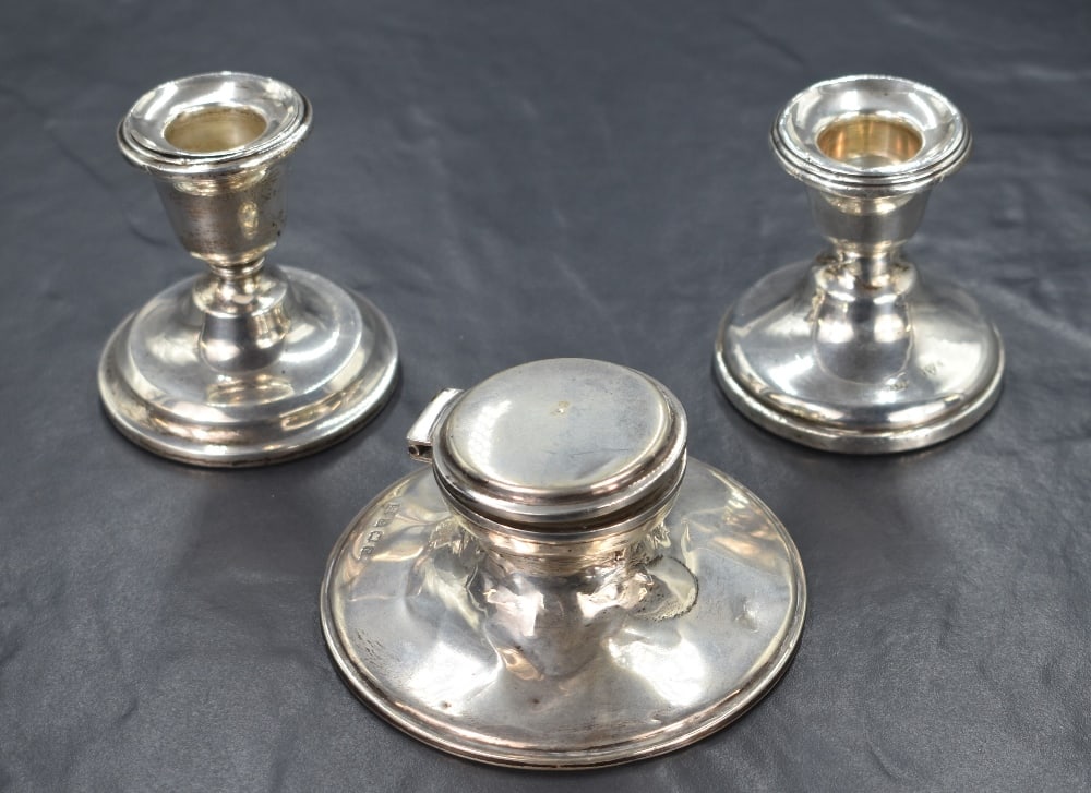 A pair of George V silver stout candlesticks, of traditional form having step moulded sconces, one: A pair of George V silver stout candlesticks, of traditional form having step moulded sconces, one engraved 'To Brown Owl From The Brownies and Their Parents 13/9/27', raised on circular step moulded