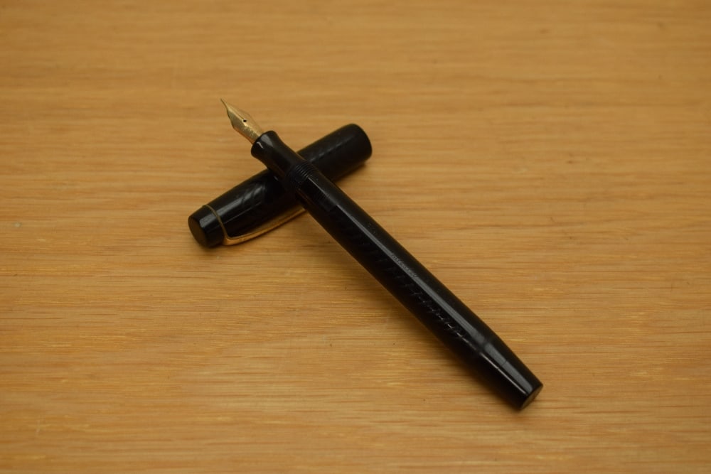 A Parker Duofold button fill fountain pen in black chaised pattern having Parker Pen Canada 2C nib: A Parker Duofold button fill fountain pen in black chaised pattern having Parker Pen Canada 2C nib