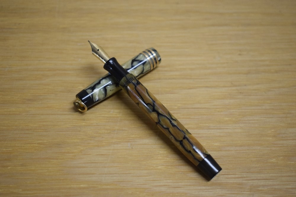 A Parker Duofold Lady Deluxe button fill fountain pen in black and pearl with three gold bands to (1 of 3)