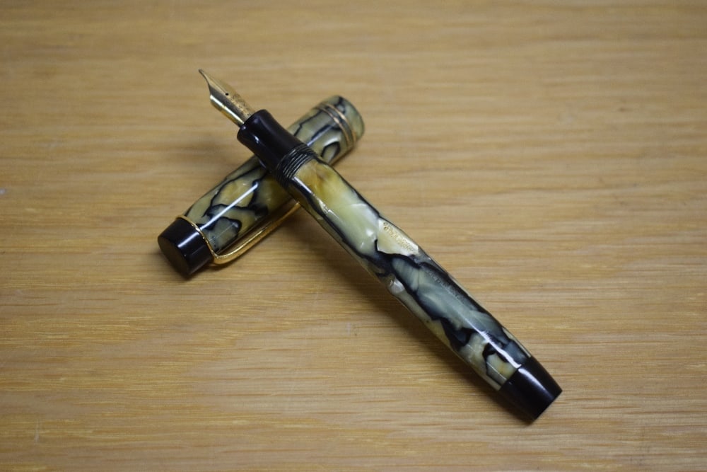 A Parker Duofold Special button fill fountain pen in black and pearl with two gold bands to the (1 of 3)
