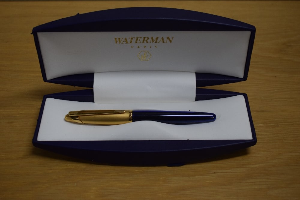 A boxed Waterman Edson rollerball pen in sapphire blue with gold cap. Booklet and refill in box. (1 of 2)