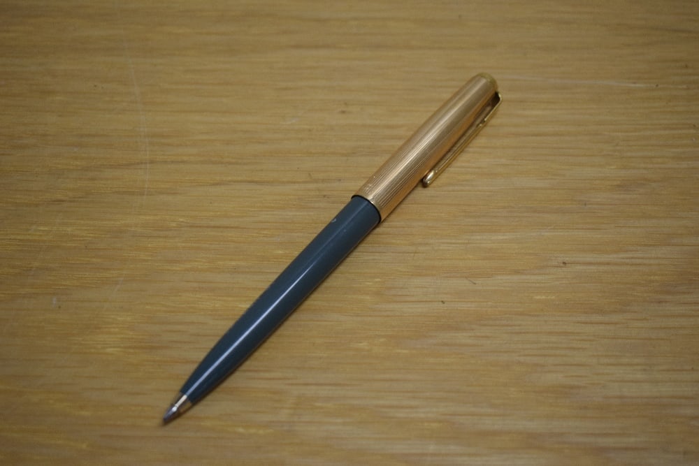 A Parker 51 ballpoint pen in grey with rolled gold cap.: A Parker 51 ballpoint pen in grey with rolled gold cap. Condition Report - No metal insert at the top of the barrel. Chalk mark "Parker 51" to barrel. No rubs or dings. Mechanism wor