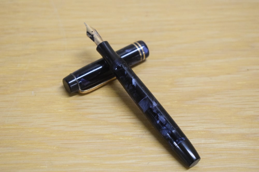 A Parker Duofold Junior button fill fountain pen in blue black marble with two cap bands having a (1 of 3)