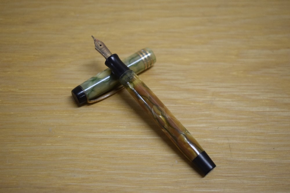 A Parker Duofold Deluxe Junior button fill fountain pen in bronze and gold with three cap bands (1 of 3)