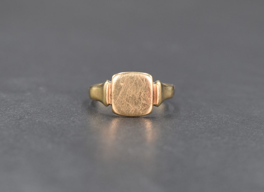 A 9ct gold signet ring, the vacant square panel having moulded shoulders, ring size P, 2.5g (1 of 3)