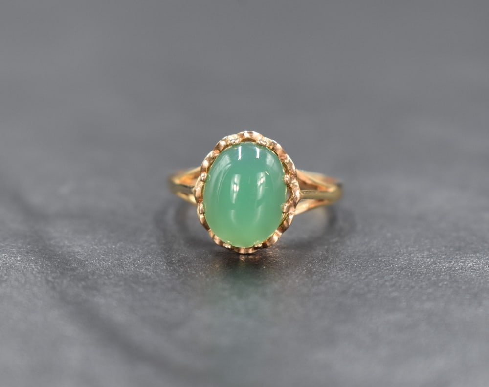 A 9ct gold green gemstone ring possibly chrysoprase, the central cabochon in an eight claw setting (1 of 3)