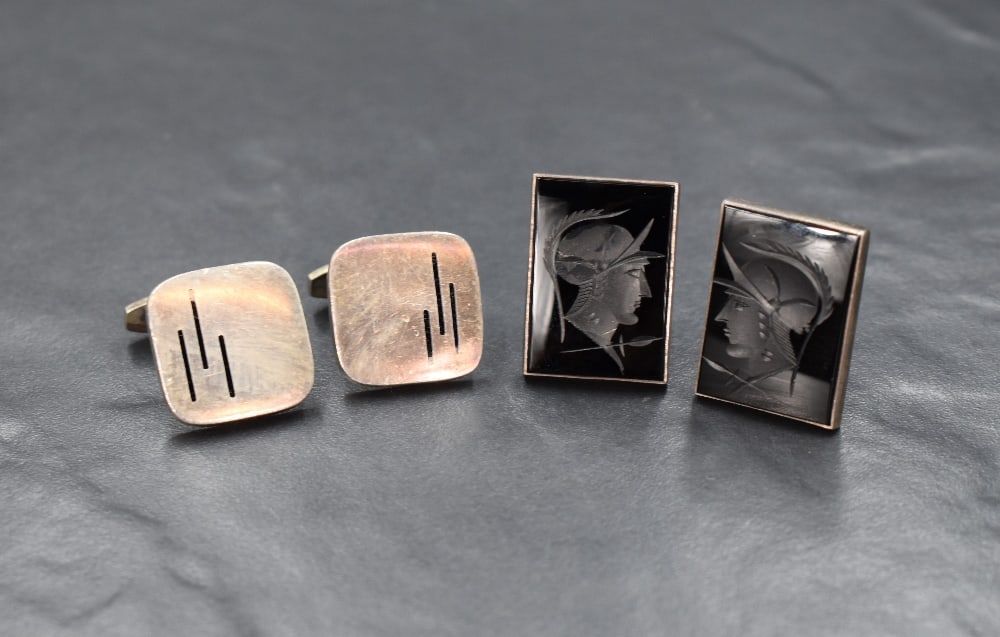 A pair of Danish silver cufflinks, the square panels having enamel line decoration on solid bar: A pair of Danish silver cufflinks, the square panels having enamel line decoration on solid bar attachments, along with a pair of silver cufflinks having rectangular black intaglio panels, 43.2g