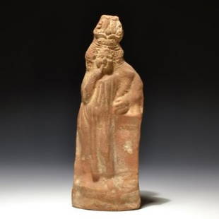 AN ALEXANDRIAN HARPOCRATES FIGURE: AN ALEXANDRIAN HARPOCRATES FIGUREEgyptian / Roman period, 2nd – 3rd cent. A.D. / Clay / H = 21 cm (8 17/64 in)Harpocrates standing with his right hand finger to his lips, holding a cornucopia in