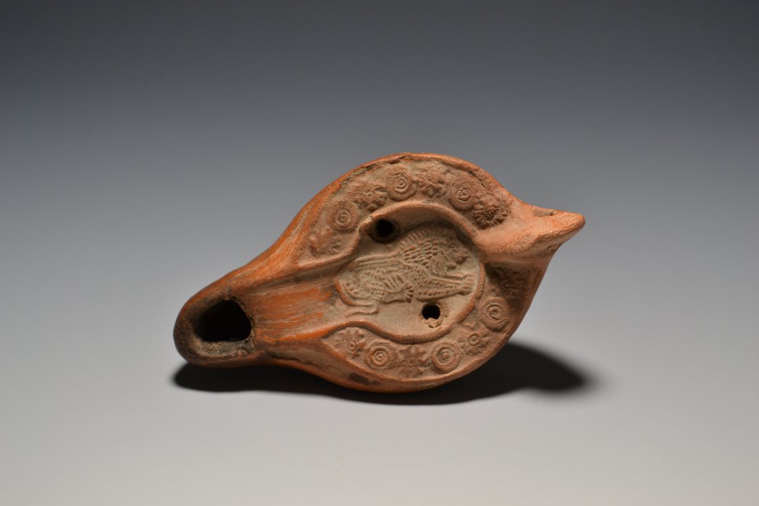 A ROMAN NORTH AFRICAN TERRACOTTA OIL LAMP DEPICTING A LION: 13 A ROMAN NORTH AFRICAN TERRACOTTA OIL LAMP DEPICTING