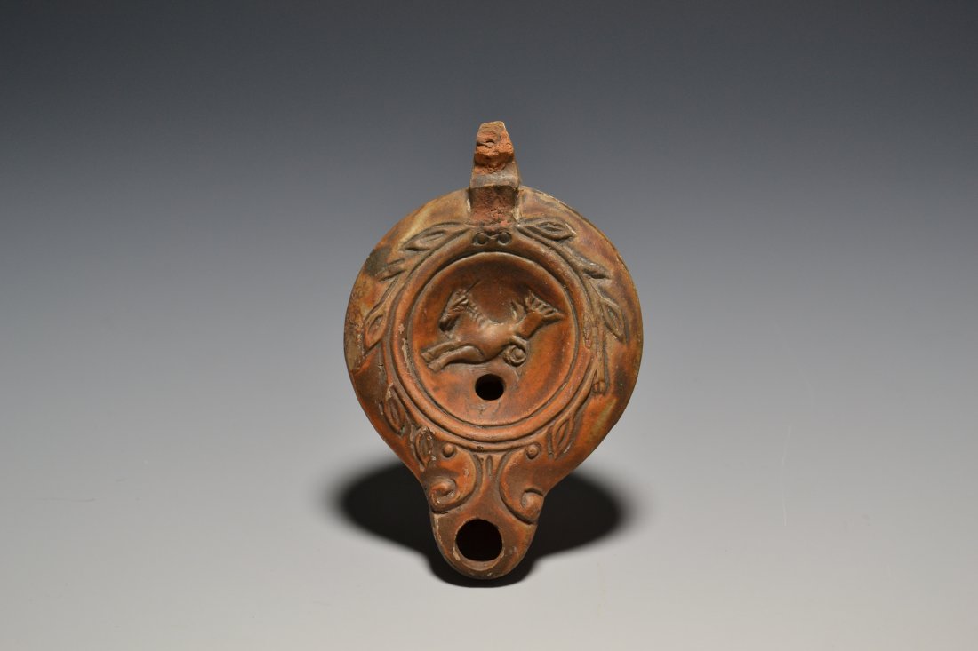 A ROMAN TERRACOTTA OIL LAMP DEPICTING A HIPPOKAMPUS (1 of 3)